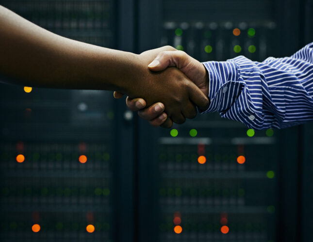 Making deals in the data center. Cropped shot of two men shaking hands in a data center
